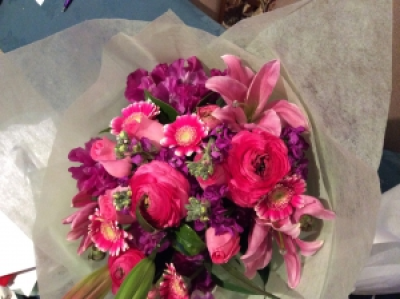 Hot pinks and purples - Lilies,stock, sweet peas, Ranunculas  and Mini Gerberas arranged in a natural stem bouquet beautifully gift wrapped. Seasonal Flowers subject to availability . Variation of colours upon request