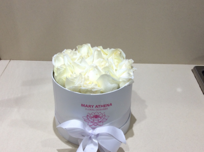 pure elegance - specified colour of roses or a mixture of flowers elegantly sculptured and arranged in a hat box. Colour of roses your personal preference.Price may vary during seasonal availability. Starting price at $80.00.